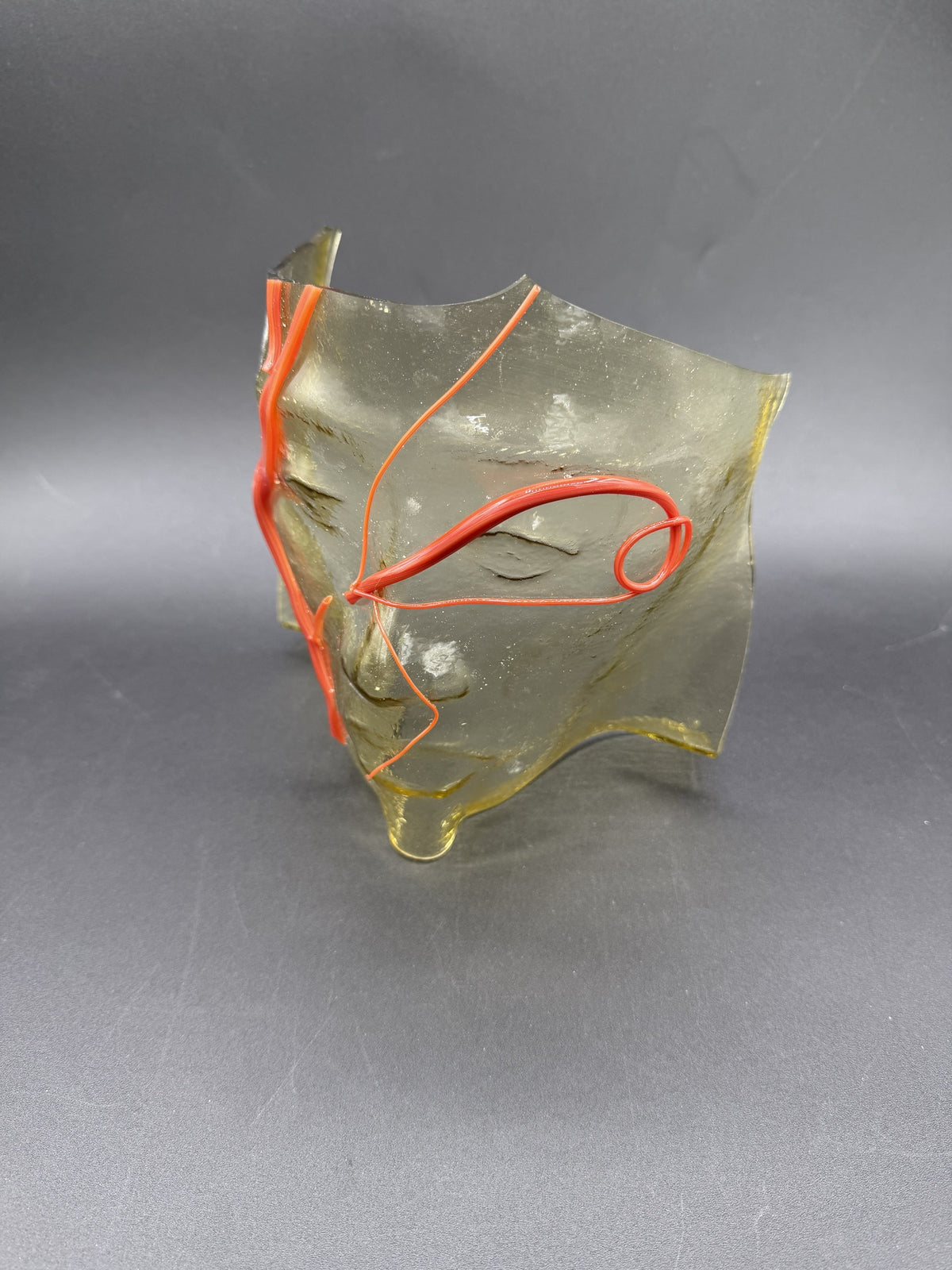 Sculpted Face with Red Lines