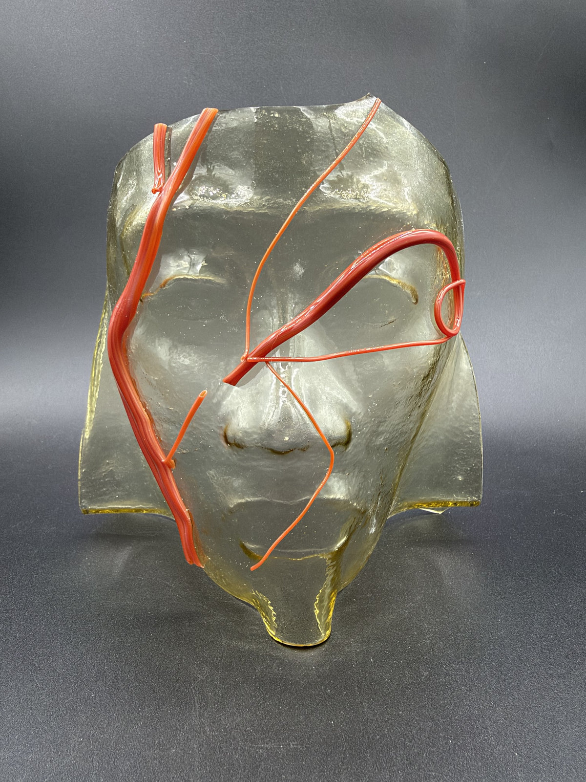 Sculpted Face with Red Lines