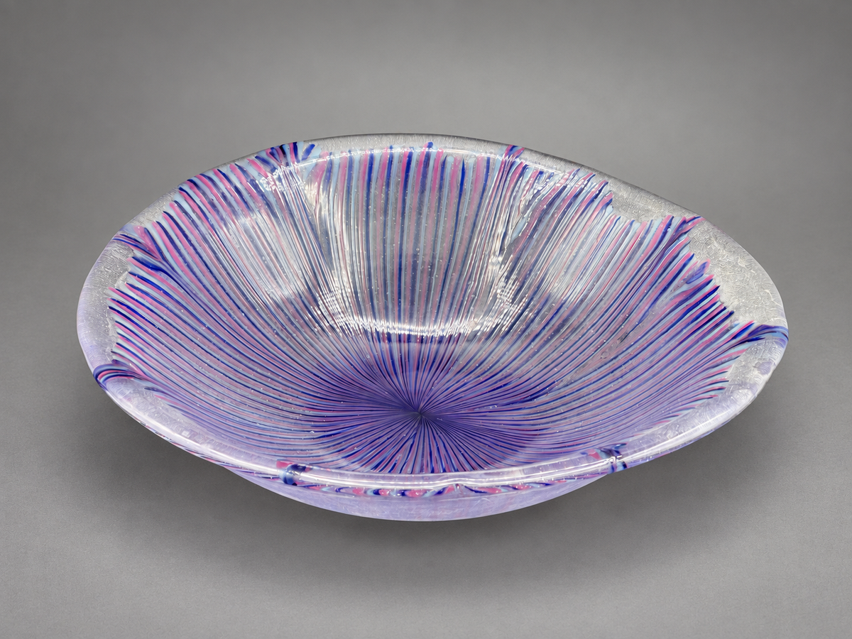 Violet, pink, and blue radiating fused-glass bowl by Paige's Glass Art.