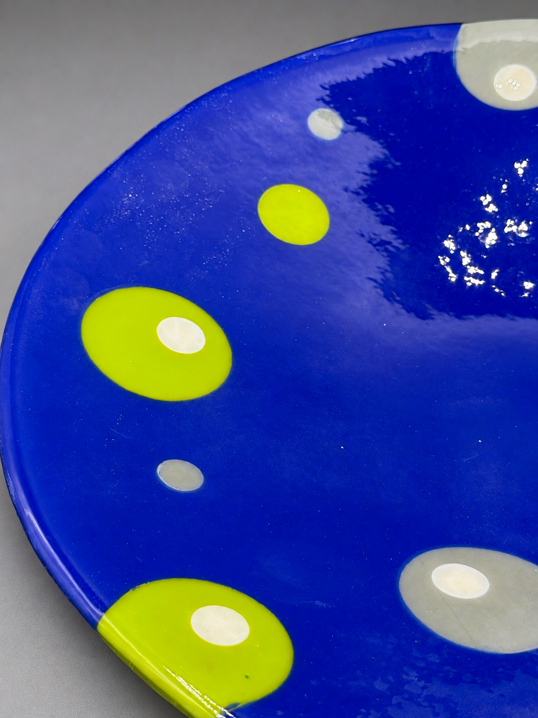Detail of the fused-glass surface and bubble pattern in the cobalt-blue Bubble Dance Platter.